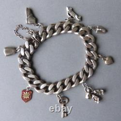 Antique solid silver curb bracelet with heart, monkey, and iron-shaped pendants