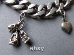 Antique solid silver curb bracelet with heart, monkey, and iron-shaped pendants