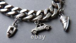 Antique solid silver curb bracelet with heart, monkey, and iron-shaped pendants