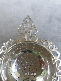 Antique solid silver tea strainer