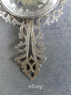 Antique solid silver tea strainer