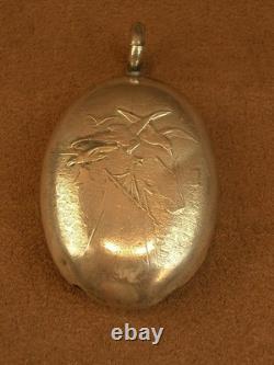 Beautiful ancient silver bell with a decoration of seagulls and swallows.