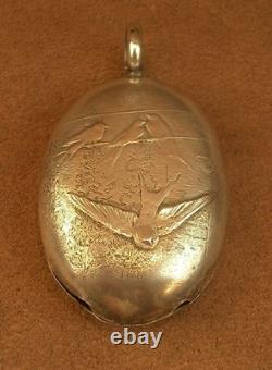Beautiful ancient silver bell with a decoration of seagulls and swallows. Beautiful ancient silver bell with a decoration of seagulls and swallows.