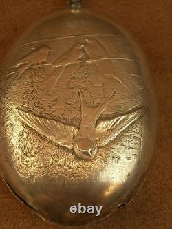 Beautiful ancient silver bell with a decoration of seagulls and swallows.