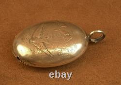 Beautiful ancient silver bell with a decoration of seagulls and swallows.