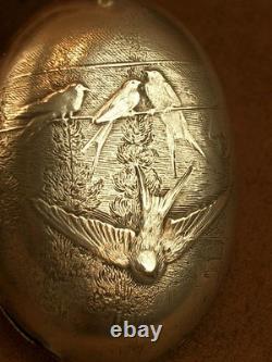 Beautiful ancient silver bell with a decoration of seagulls and swallows.