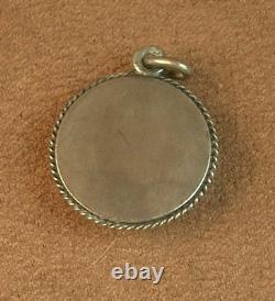 Beautiful old pendant in solid silver and Bressan enamels with a green background